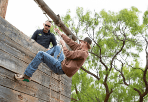 Student and professor at a ropes course for class at the Abilene Police Academy